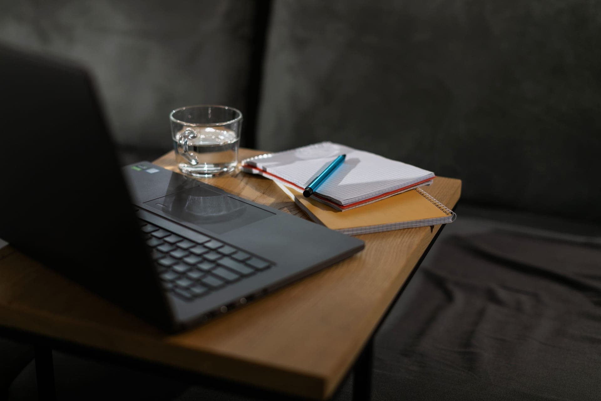 A desk with a notebook and laptop