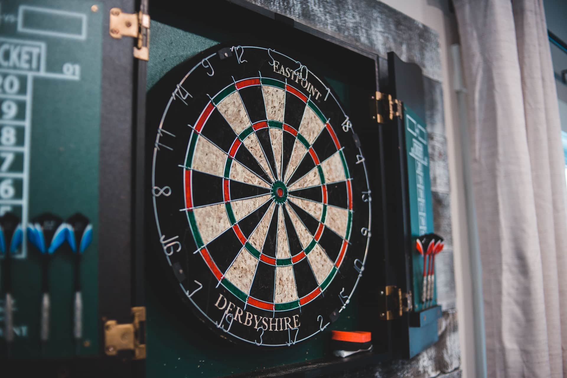 A dartboard hanging on a wall in a home