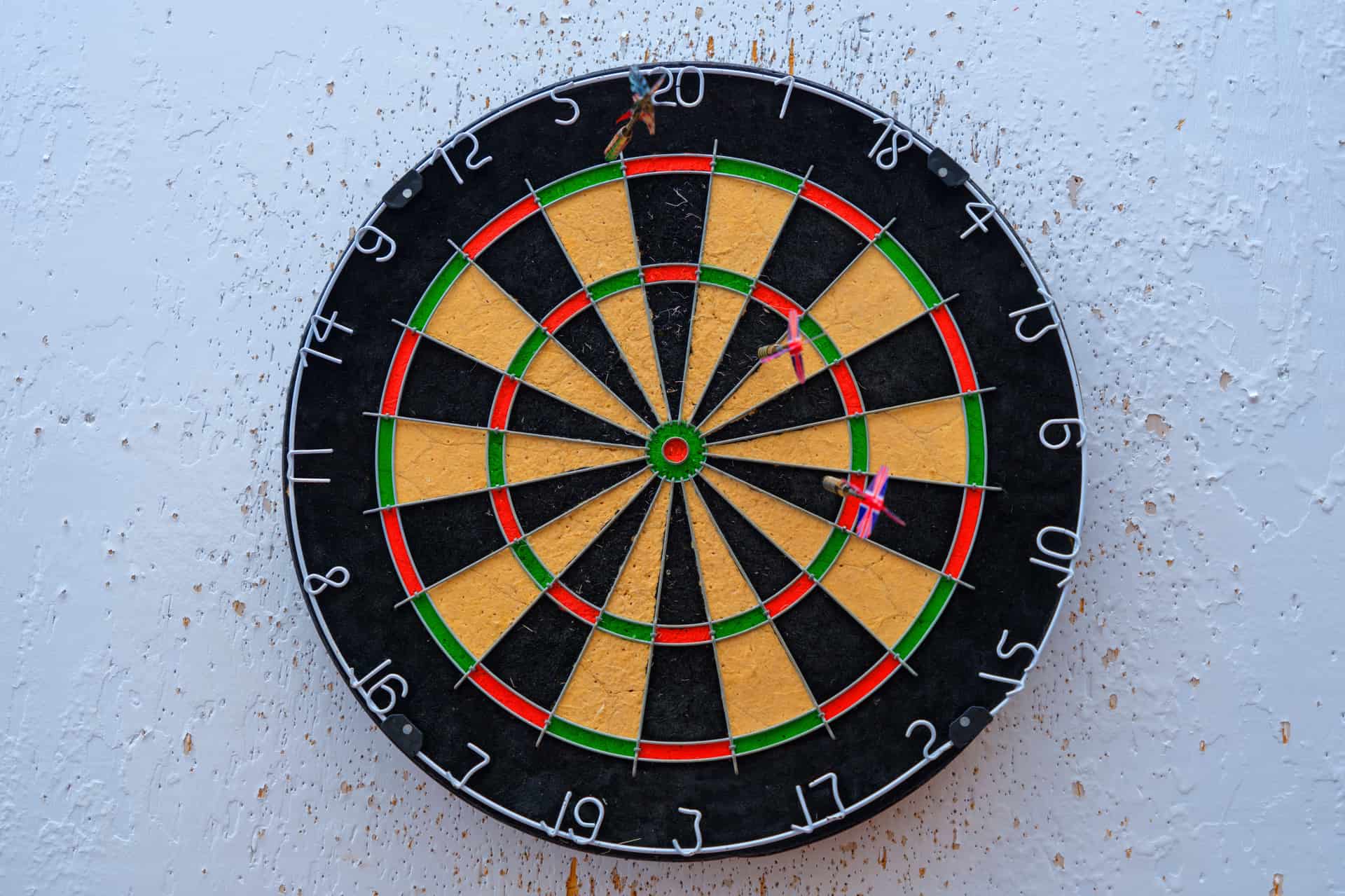 A dartboard with darts in the bullseye
