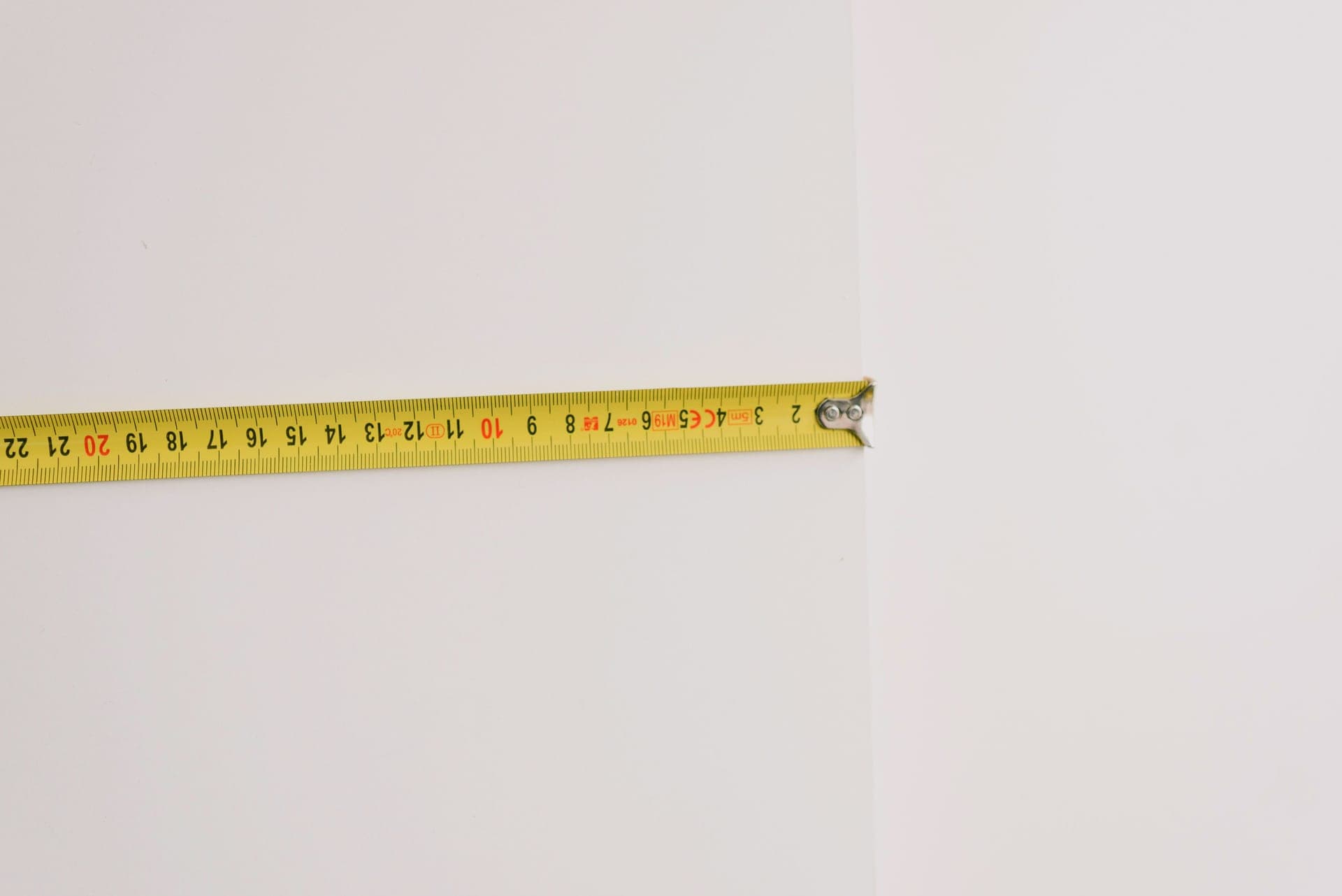 A measuring tape against a wall in a room