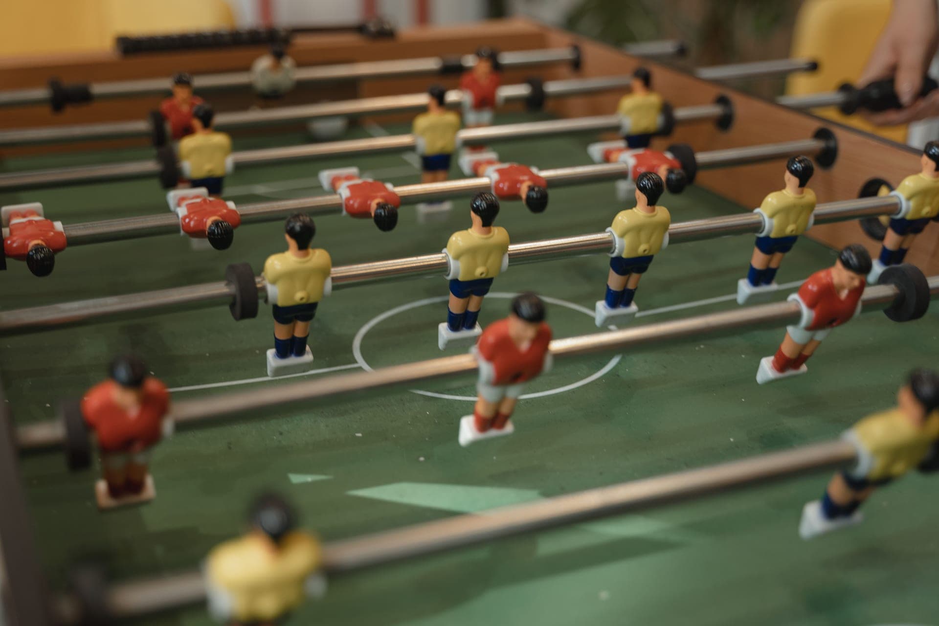 A tabletop foosball game on a dining table
