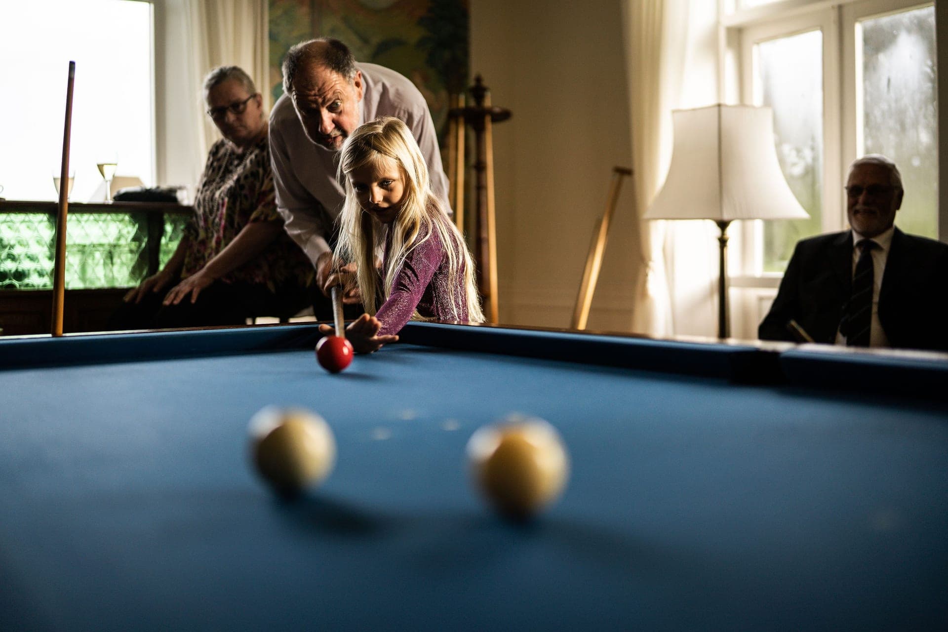 A family playing pool together at home