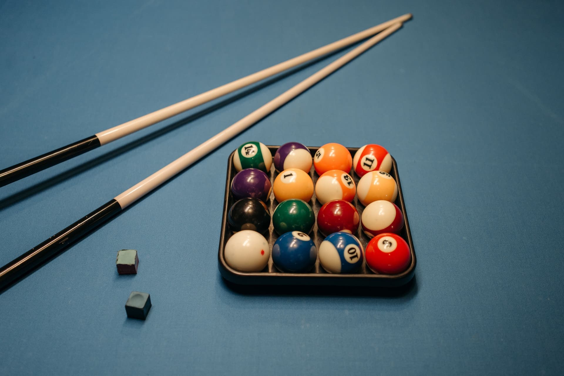 Pool cues and billiard balls on a table