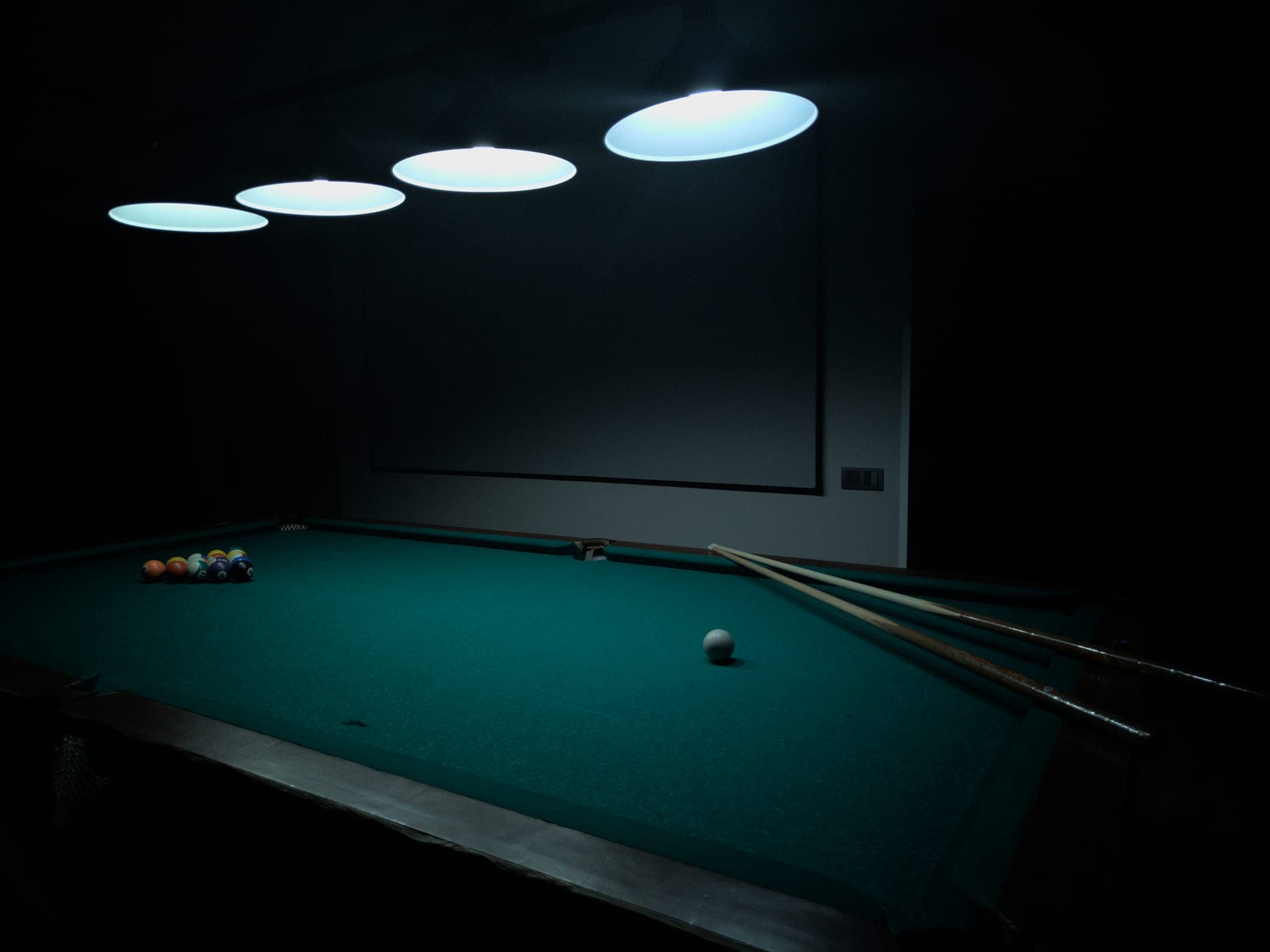 A pool table with cues and balls ready for a game