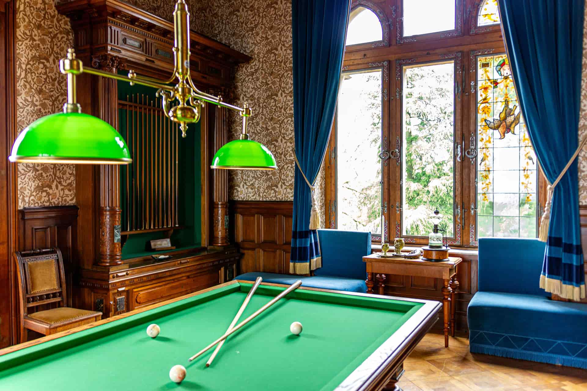 A space-saving pool table against a wall in a narrow room